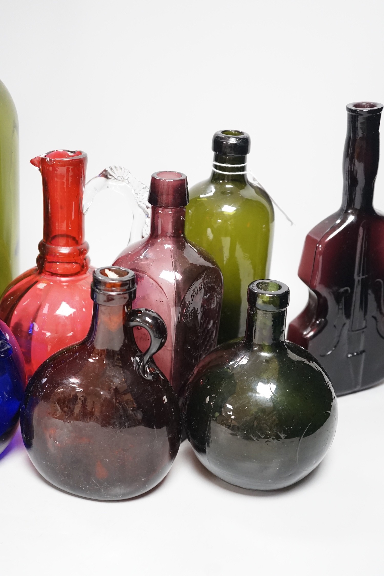 A collection 19th/20th century coloured glass bottles and jugs
